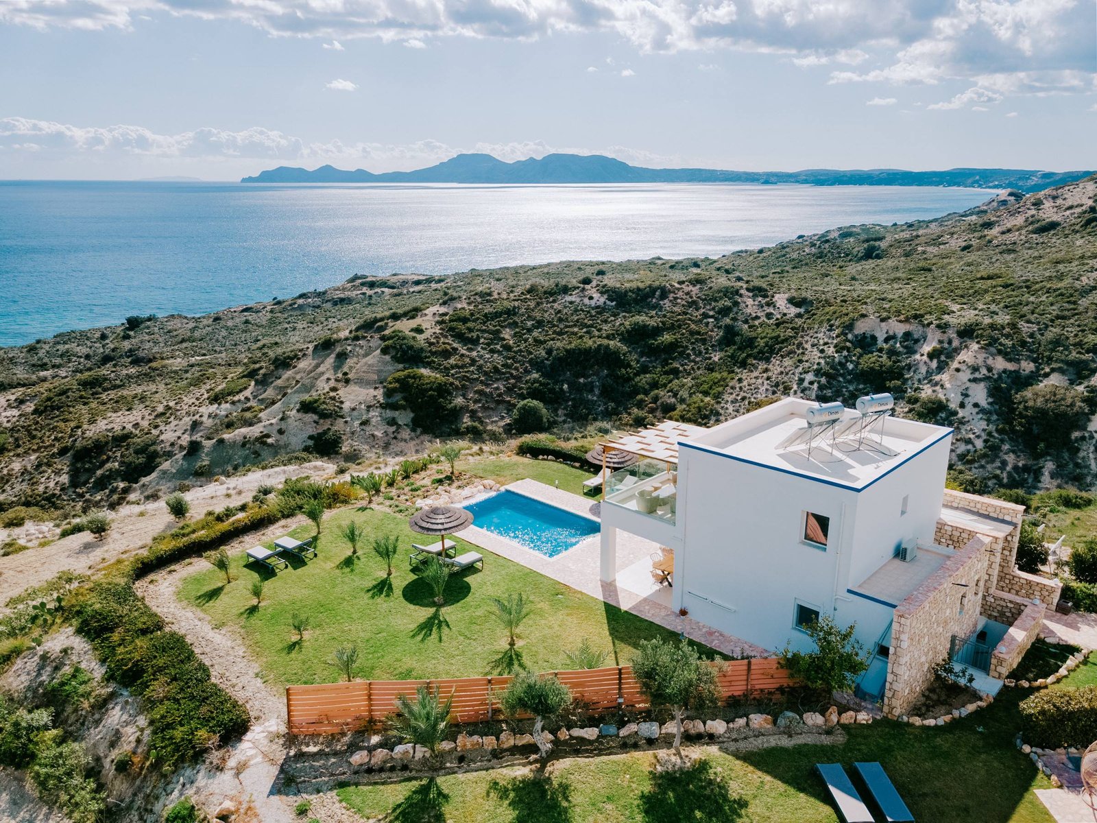 Aerial view of a Three Graces villa with private pool above the Aegean Sea, Kos