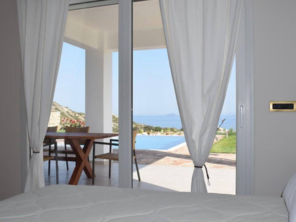 Villa Apollon bedroom opening to the terrace and pool