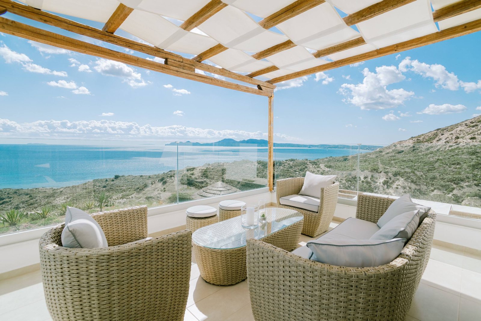 Upper balcony with wicker lounge and panoramic sea view
