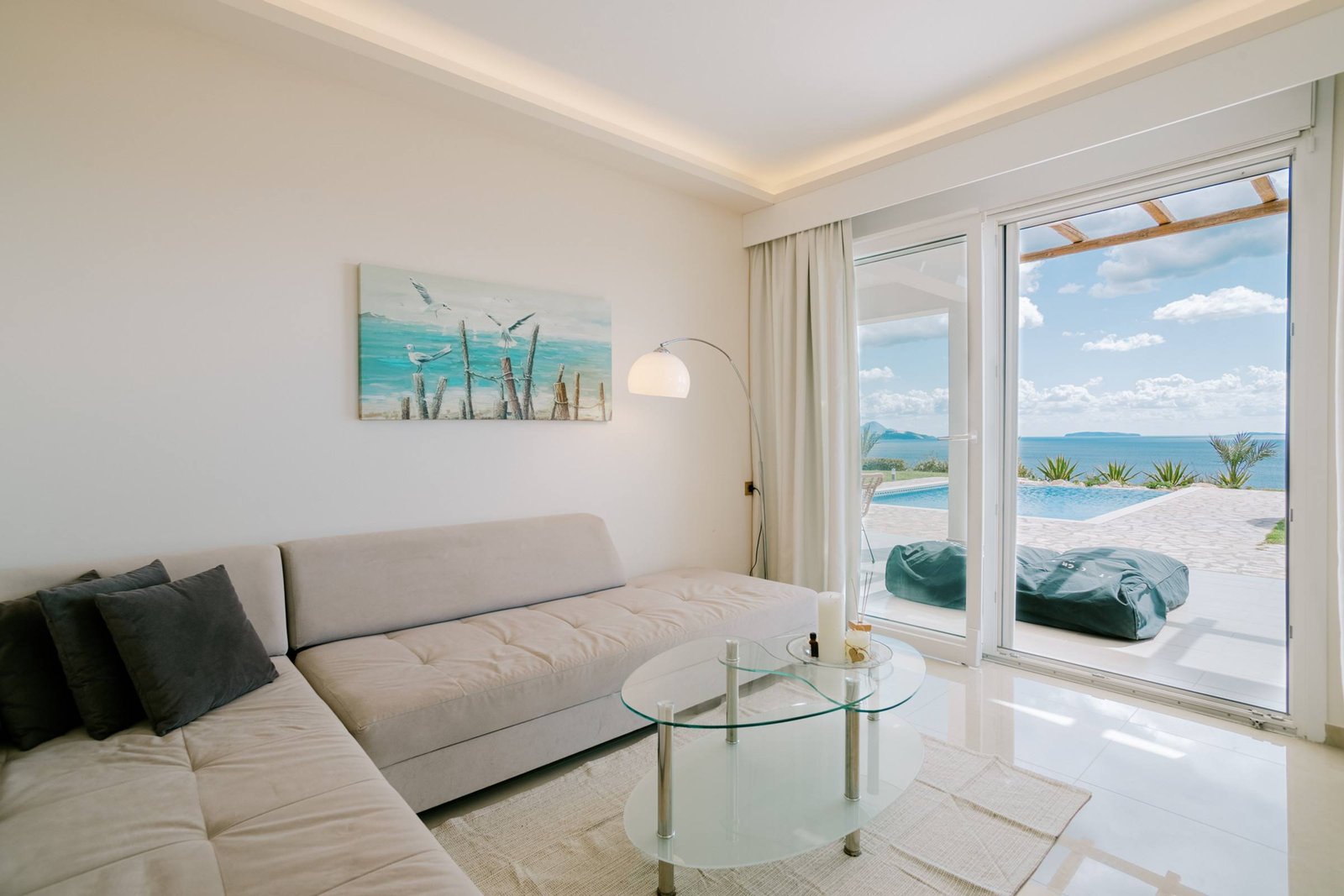 Bright living room with sofa and sliding doors to the pool terrace